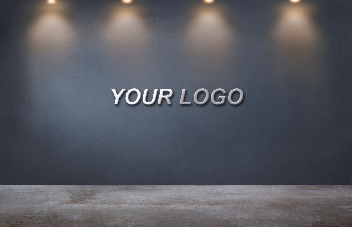 Photoshopのモックアップ。暗い壁に仮の文字YOUR LOGOが立体的に乗っている